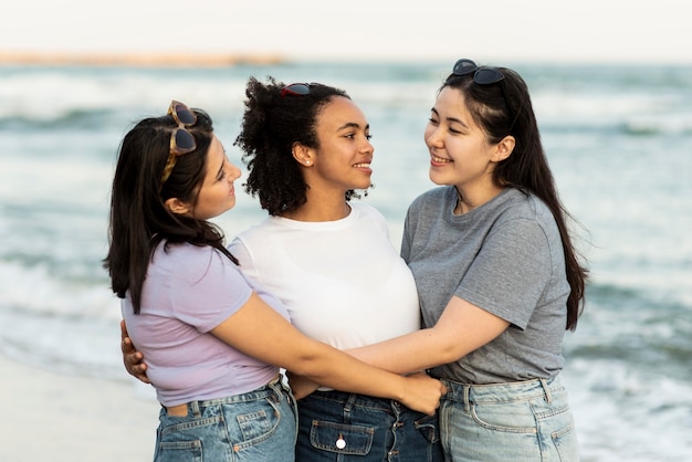 Amici femminili abbracciati sulla spiaggia