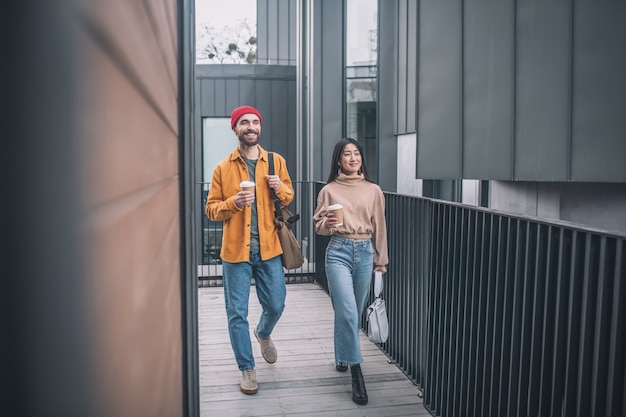 Amici. Giovane uomo e donna in abiti casual che camminano insieme