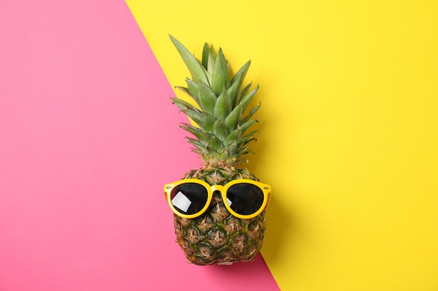 Ananas con occhiali da sole su due toni, spazio per il testo