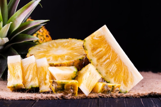 Ananas fresco su fondo nero di legno nero