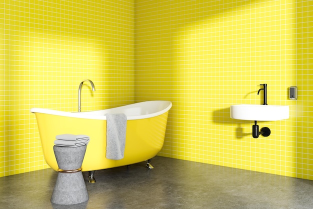 Angolo bagno giallo con pavimento di cemento, vasca da bagno gialla e lavandino rotondo.