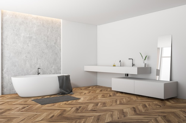 Angolo del bagno moderno con pareti bianche e cemento, pavimento in legno, vasca bianca con asciugamano e lungo lavabo bianco con specchio. rappresentazione 3d