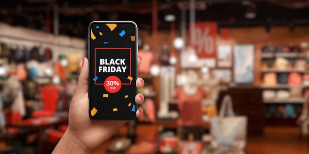 Annuncio di vendita del black friday sul cellulare Il concetto di shopping online Negozio con sconti in background