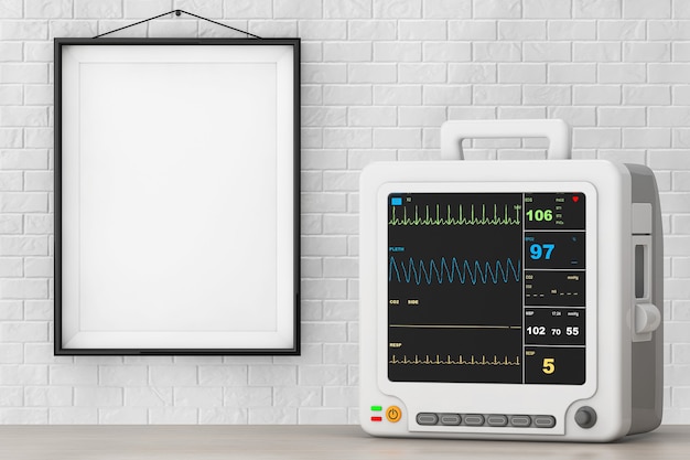 Apparecchiature per il monitoraggio cardiaco portatile di assistenza sanitaria davanti al muro di mattoni con cornice vuota.