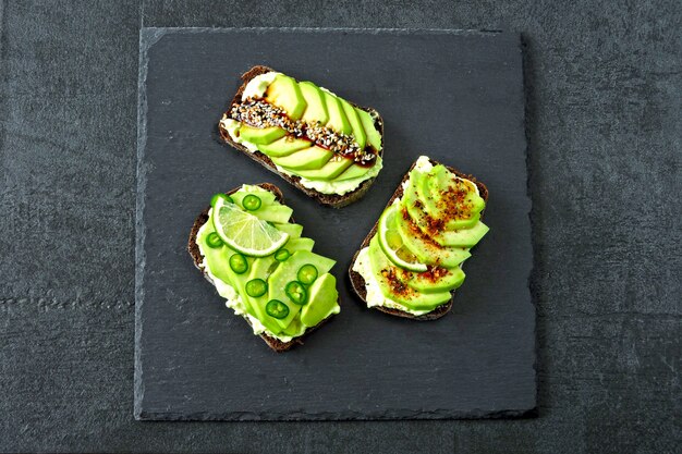 Appetitosi toast di avocado con splendidi condimenti.