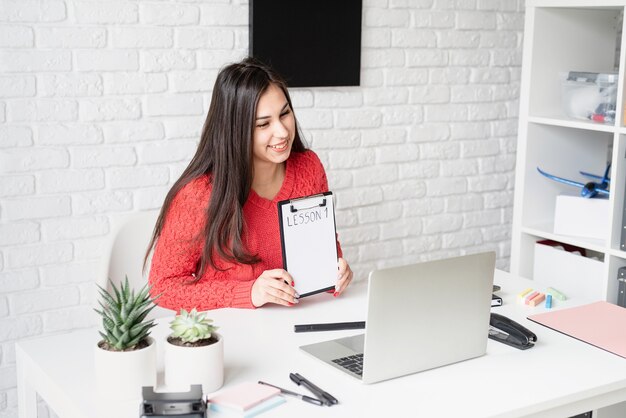 Apprendimento a distanza con la donna che insegna inglese online utilizzando il computer portatile