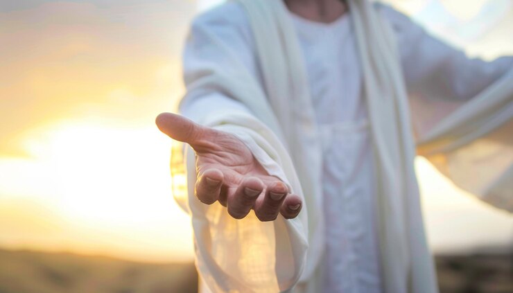 arafed man in white robe holding out his hand with a sunset in the background generative ai