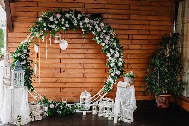 Arco per la cerimonia di matrimonio a è decorato con fiori bianchi e verdi verdi Photowall spazio o posizionare le candele sullo sfondo della parete in legno Decorazione di nozze in stile boho Acchiappasogni