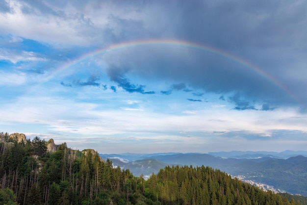 Arcobaleno con colori su un cielo nuvoloso su una valle dei Monti Rodopi