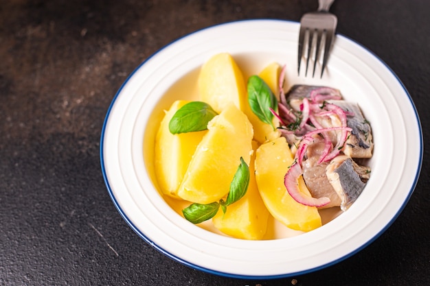 Aringhe e patate secondo piatto di pesce marinato cipolla fresca pasto pronto spuntino in tavola