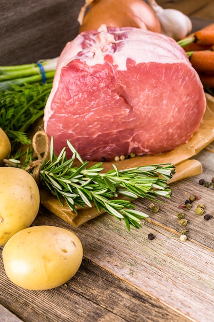 Arrosto di leone di maiale biologico con rosmarino su tavola da fattoria in legno.