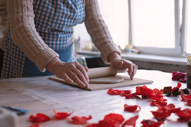 Artigiano femminile senior che crea ceramiche fatte a mano nello studio della ceramica