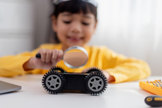 asia students learn at home in coding robot cars and electronic board cables in stem steam mathematics engineering science technology computer code in robotics for kids concept