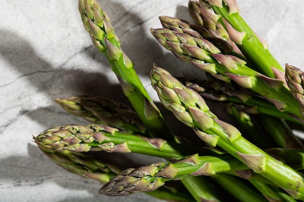 Asparagi su fondo marmo. fotografia di cibo a luce dura. Mangiare sano concetto. Cibo vegetariano.