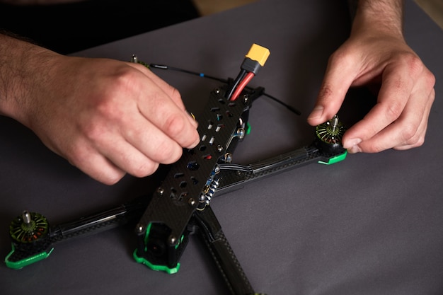 assemblaggio di un drone da parti utilizzando strumenti Preparazione del quadricottero da corsa ad alta velocità per il volo