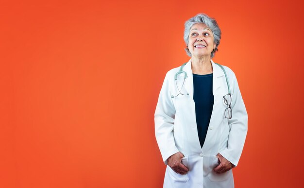 Assistenza sanitaria - medico brasiliano maturo o donna veterinaria con stetoscopio isolato su Orange