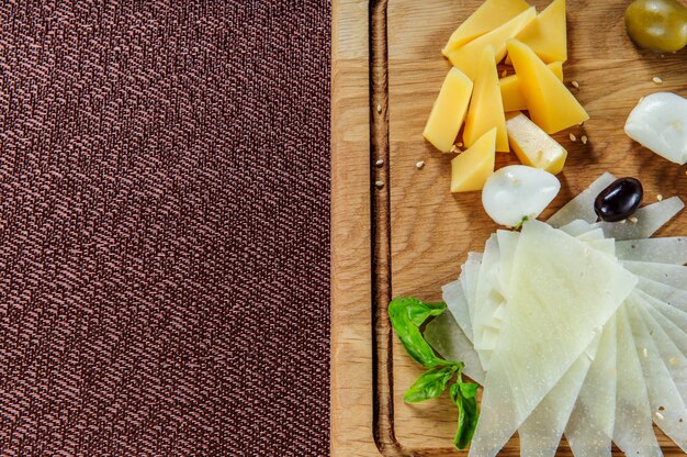 Assortimento di formaggio su un fondo di legno rustico tagliere.