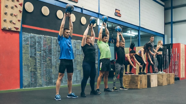 Atleti che si allenano con i kettlebell e fanno box jump