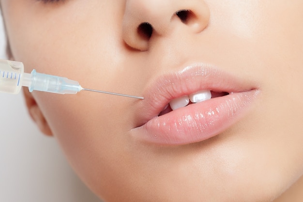 Attractive young woman gets cosmetic injection