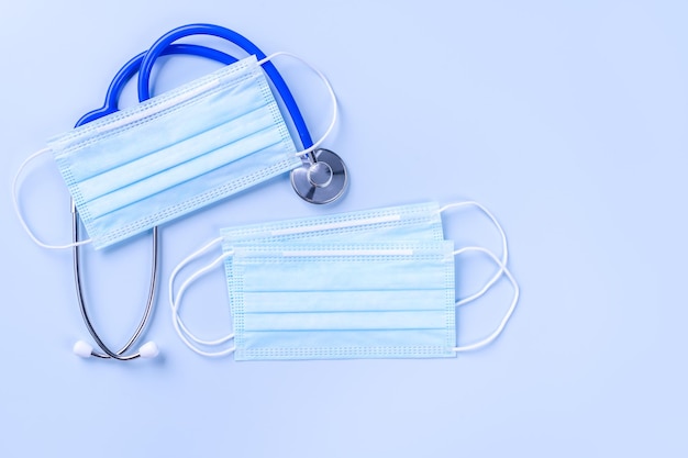 Attrezzatura medica con maschera blu con concetto di stetoscopio di infezione pandemica mondiale di malattie e prevenzione vista dall'alto design piatto a testa piatta