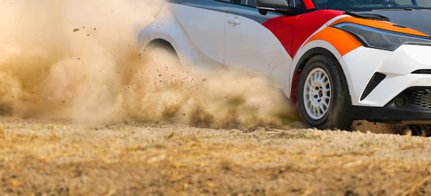 Auto da corsa da rally alla deriva in curva su sterrato.