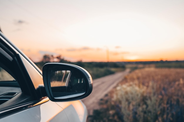 Auto da turismo in autostrada con paesaggio al tramonto