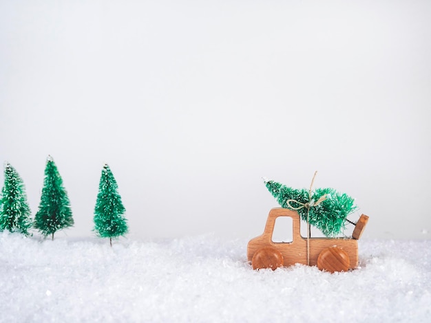 Auto in legno con albero di Natale Il concetto di inverno il nuovo anno