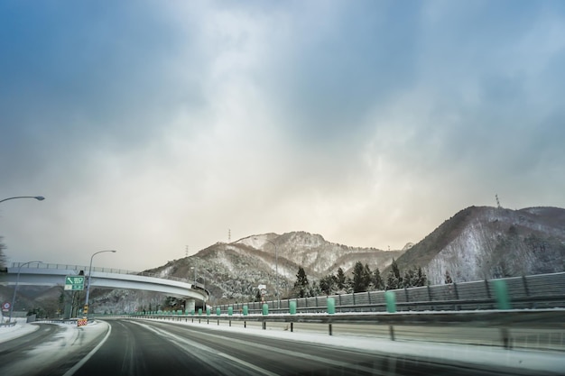 Autostrada giapponese attraverso la montagna di neve in inverno