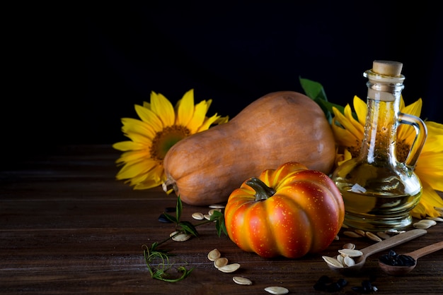 Autunno natura morta con zucche, olio e girasoli