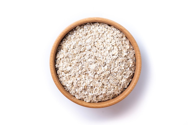 Avena arrotolata fiocchi di avena di cereali per colazione sani in una ciotola isolati su sfondo bianco