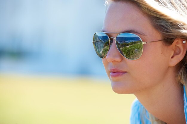 Aviator chic Colpo ritagliato di una donna attraente con occhiali da aviatore