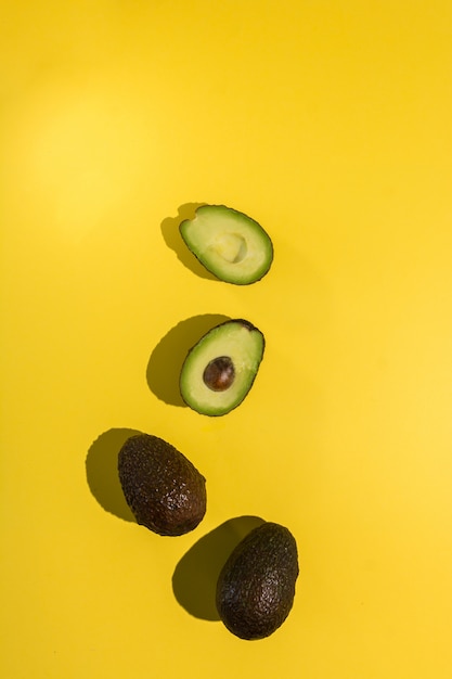 Avocado tagliato su giallo isolato