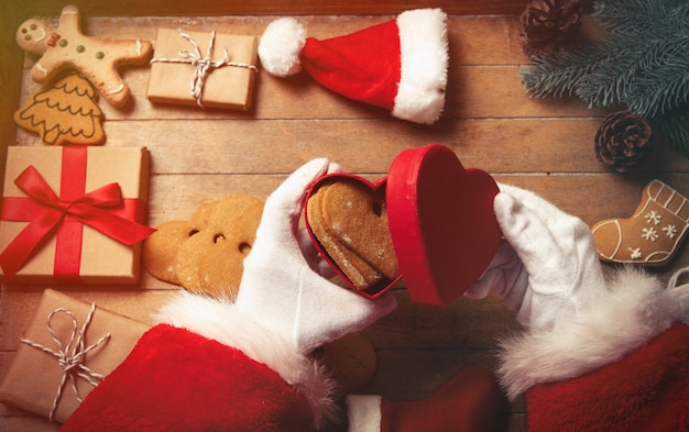 Babbo Natale avvolgendo regali e biscotti di Natale