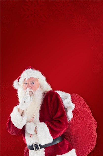 Babbo Natale chiede silenzio con borsa su sfondo rosso