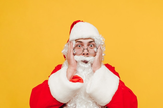 Babbo Natale emotivo sta toccando la sua testa con le mani