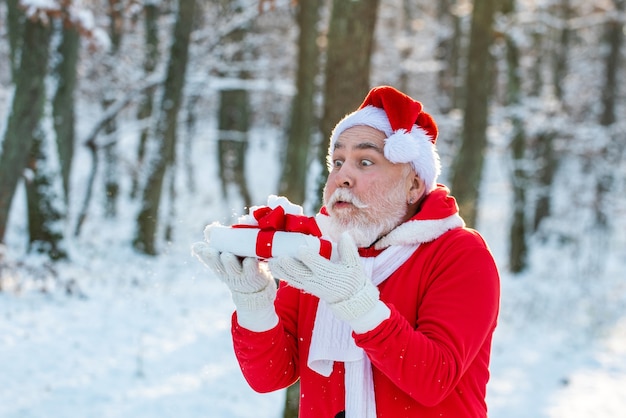 Babbo Natale soffia via la neve dal regalo