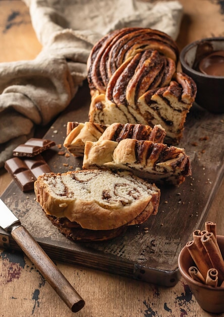 Babka al cioccolato o pane brioche Pane fatto in casa con lievito di pasta dolce al cioccolato affettato su tavola di legno rustica