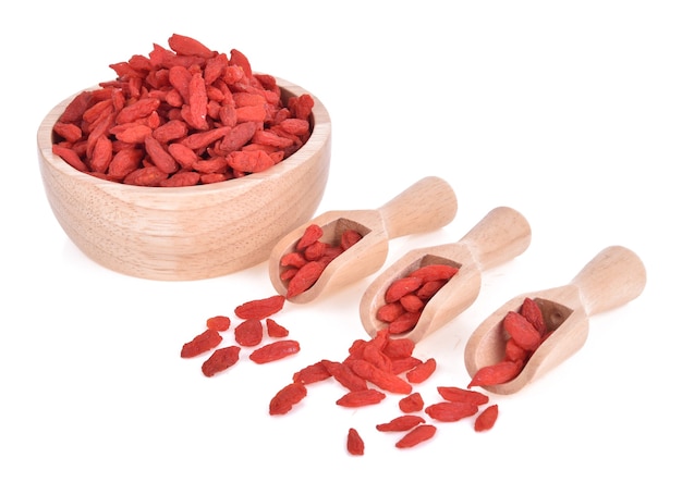 Bacche di Goji in ciotola di legno isolata.