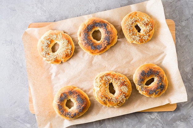 Bagel al forno con semi di papavero e semi di sesamo su pergamena Dolci fatti in casa Vista dall'alto