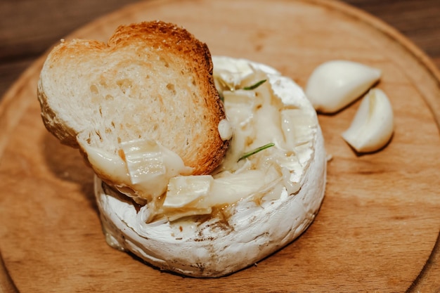 Baguette bianca con olio d'oliva e Camembert al forno sul tavolo