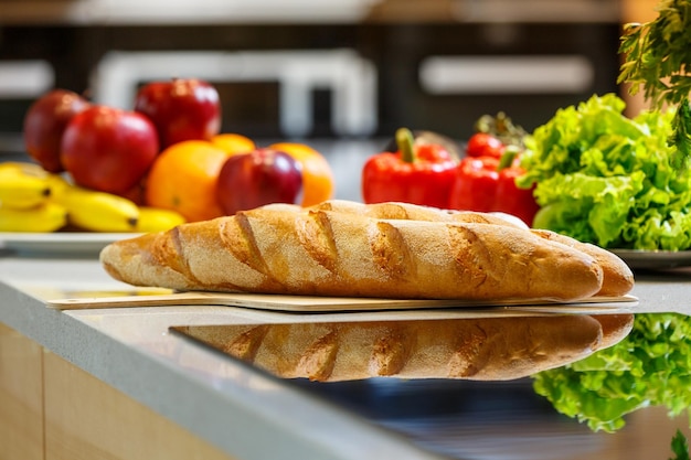 Baguette fresche sdraiate su un tagliere in una cucina