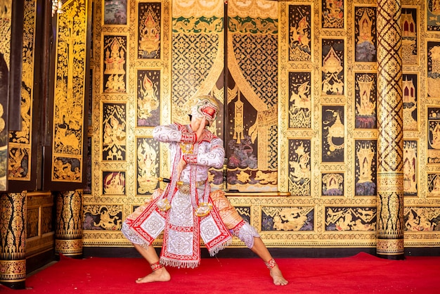 Ballerino tipico thailandese con abiti tipici su sfondo pareti dorate