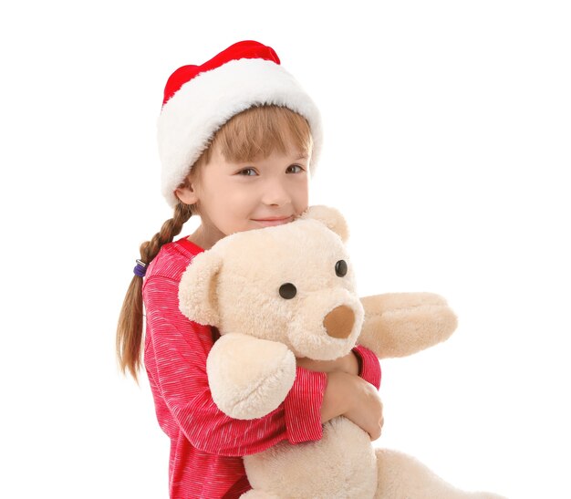 Bambina carina con cappello da Babbo Natale con giocattolo