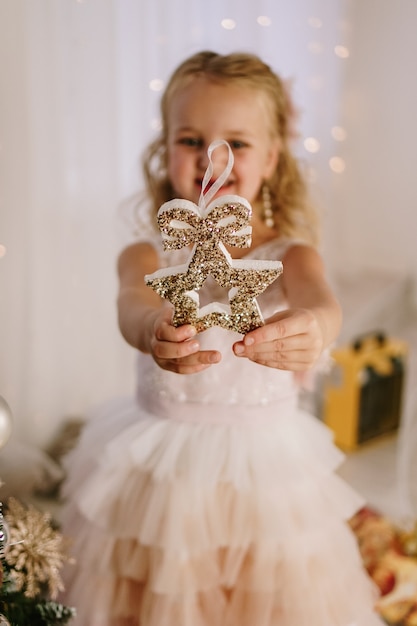 Bambina carina con una stella di Natale in mano