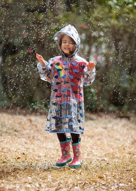 Bambina che gioca sotto la pioggia