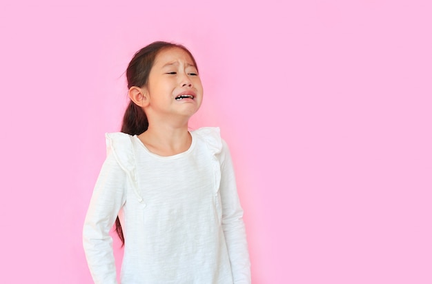 Bambina che grida sul fondo rosa