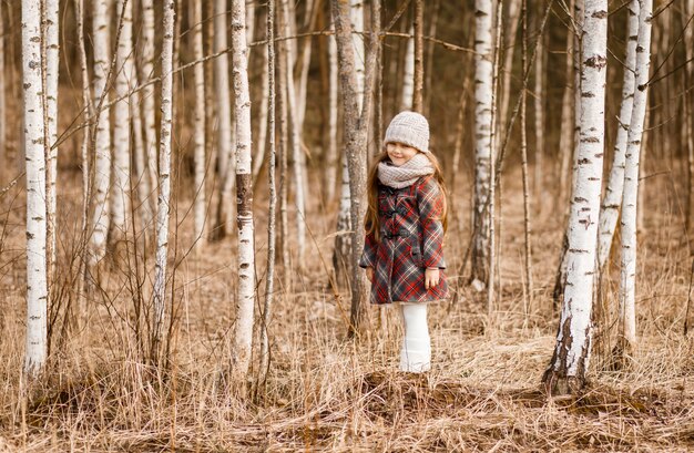 Bambina che posa nella foresta