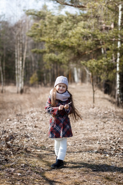 Bambina che posa nella foresta