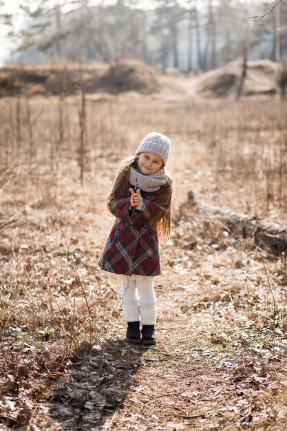 Bambina che posa nella foresta