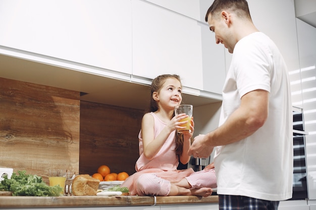 Bambina con i capelli lunghi. Padre e figlia insieme. La famiglia si prepara da mangiare.